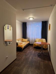 a room with a bed and a table and a couch at Кемпинг Мечта in Uralsk