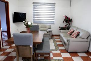 a living room with a couch and a table at Departamento Bugambilia in Oaxaca City