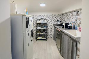 a kitchen with a refrigerator and a sink at Unda Maris in Cisternino