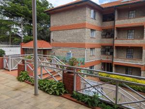 a balcony with a metal railing and a building at Westlands bliss By bliss haven in Nairobi
