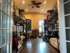 a room with bunk beds and a ceiling fan at Ferry Hostel in Newark