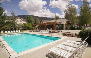 a swimming pool with chairs and a gazebo at Eden Escape most desirable floor plans in all of Moose Hollow Luxury Condos in Eden