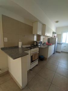 a kitchen with a stove and a counter top at Talcahuano in Guaymallen +1 photo