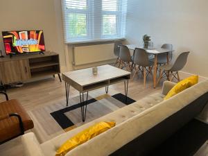 a living room with a couch and a table at Spectacular London Stay in Crystal Palace