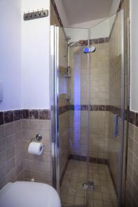 a bathroom with a glass shower with a toilet at La Casetta Nel Vico in Polignano a Mare +35 photos