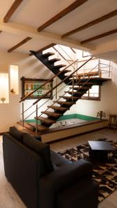 a spiral staircase in a living room with a couch at Villa Oasis cafetero in La Tebaida
