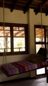 a bed in a room with two windows at Villa Oasis cafetero in La Tebaida +49 photos