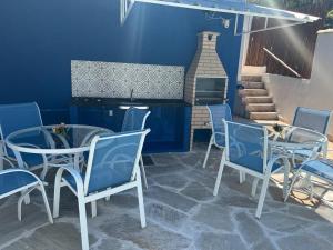 a patio with a table and chairs and a fireplace at Pousada Villa Margarida in Búzios