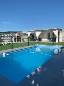 a swimming pool in front of a house at PALMAR A Tres Minutos Andando De La Playa NO GRUPOS in El Palmar
