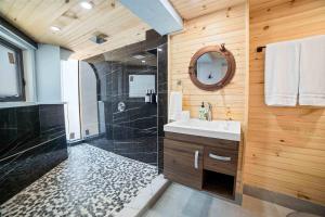 a bathroom with a shower and a sink and a mirror at Ocean Depth Room at Barnacle Resort in Big Pine Key