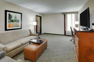 a living room with a couch and a flat screen tv at Drury Inn & Suites Springfield in Springfield