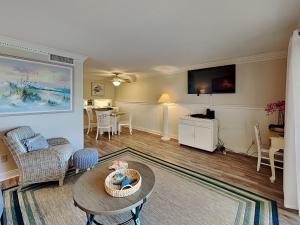 a living room with a couch and a table at Bent Palm 218 in Ormond Beach
