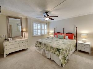 a bedroom with a bed and a ceiling fan at Bent Palm 218 in Ormond Beach