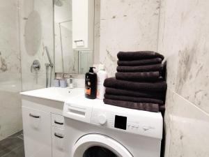 a bathroom with a washing machine and a sink at Cozy Apartments in Central Location with Free Parking on Availability in Vienna +130 photos