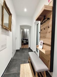 a living room with a bench and a mirror at Cozy Apartments in Central Location with Free Parking on Availability in Vienna