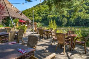 a row of tables and chairs at a restaurant at Hotel-Restaurant Eifeler Seehütte in Rieden