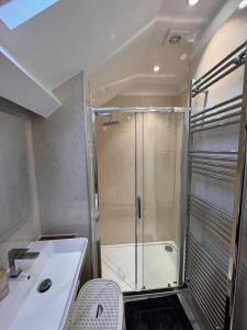 a bathroom with a shower and a sink at The Old Coach House - Hot Tub - Dorset in Pimperne +39 photos
