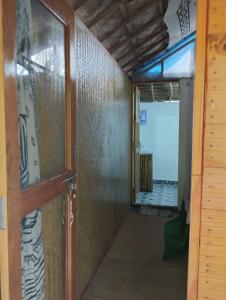 a hallway leading to a room with a door at Ruban Yoga in Palolem
