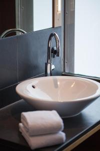 a white sink sitting under a mirror in a bathroom at Hotel Schloss Waldeck in Waldeck