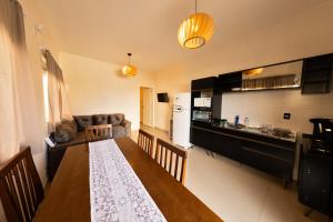 a kitchen and dining room with a dining room table and a kitchen at Residencial Beija-Flor in Palhoça