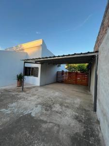 a garage in a white building with a gate at Tu Lugar II in Colón +3 photos