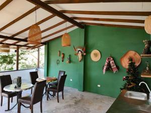 a dining room with green walls and a table and chairs at Finca Villa Laura in Támesis