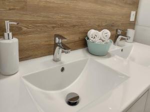 a white bathroom sink with a bowl of towels at Gîte in Etretat near Cliffs & Beach in Bordeaux-Saint-Clair +33 photos