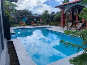 a swimming pool with blue water in a house at Hospedaje Hefziba in Moyogalpa