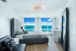 a bedroom with a bed and a view of the ocean at Luxury - Ocean front - 3 Bedroom 2 Bathroom - Penthouse in Miami Beach +16 photos
