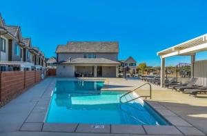 a swimming pool with a patio and a house at Luxury Red Rock Townhome - 42- St George Santa Clara in Santa Clara