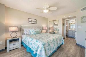 a bedroom with a bed and a ceiling fan at Seas The Day - Stunning Ocean Views, Direct Beach Access, Prime Location! in Myrtle Beach +27 photos