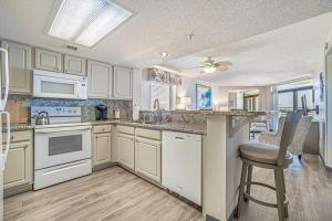 a kitchen with white cabinets and a counter top at Seas The Day - Stunning Ocean Views, Direct Beach Access, Prime Location! in Myrtle Beach