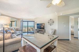 a living room with a couch and a table at Seas The Day - Stunning Ocean Views, Direct Beach Access, Prime Location! in Myrtle Beach