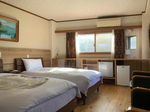 Postel nebo postele na pokoji v ubytování Izu-no-umi Hotel