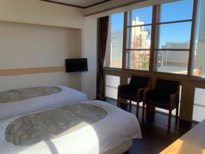 Postel nebo postele na pokoji v ubytování Izu-no-umi Hotel