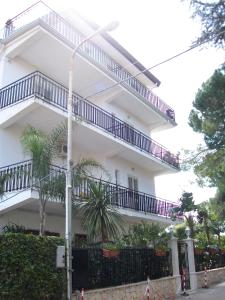 a white building with balconies on the side of it at Villa Santantonio in Giardini Naxos