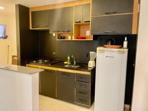 a kitchen with a sink and a stove top oven at Apto1 - Próximo ao Shopping Metrópole in Ananindeua