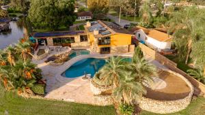 an aerial view of a house with a swimming pool at Luxury Lakefront 100,000 Gal Pool Villa - Orlando in Orlando