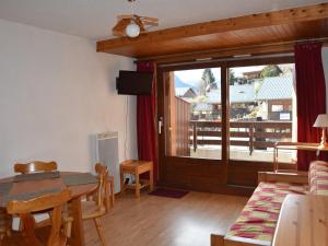 a living room with a table and a sliding glass door at Studio cabine centre station, proche remontées - FR-1-464-246 in Champagny-en-Vanoise