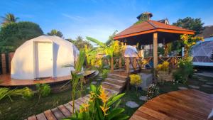 a gazebo and a tent in a yard at Domea Thakhek - Urban Glamping in Thakhek