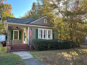 a house with a flag on the front of it at The Parkside Cottage Lakebottom Park at Doorstep! in Columbus