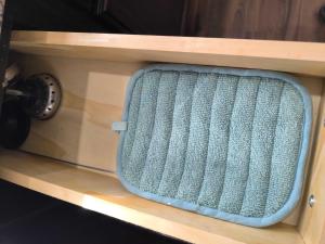 a wooden shelf with a blue box on it at The Capital Cottage New Home Near USC & Bases in Columbia