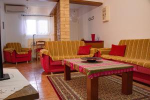 a living room with two couches and a table at Triangle Park Apartments A2 in Kozani