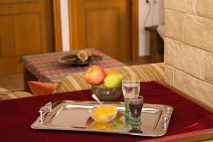 a tray with fruit and drinks on a table at Triangle Park Apartments A2 in Kozani +26 photos