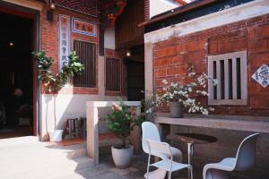 a patio with chairs and a table and a building at 序室 Narrative in Jinhu