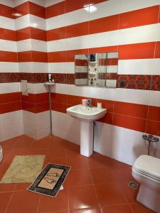 a bathroom with a sink and a toilet at ALYAM Comfortable apartment In Baku in Baku