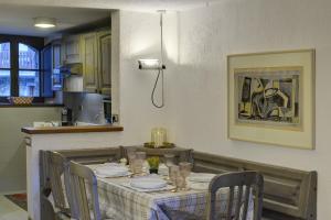 a dining room table with chairs and a tablecloth on it at Coeur Blanc in Verrand +16 photos