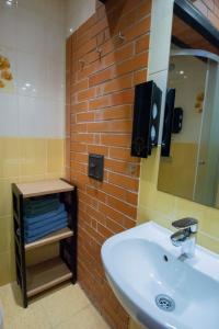 a bathroom with a sink and a brick wall at KarlovaIdyll 2 - Cozy Apartment in a Quiet Area with FREE Parking in Tartu +42 photos
