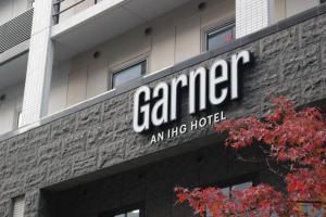 a sign on top of a building at Garner Hotel Osaka Honmachi Station by IHG in Osaka