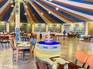 a tent with tables and chairs in a restaurant at Panorama Wadi Rum in Wadi Rum